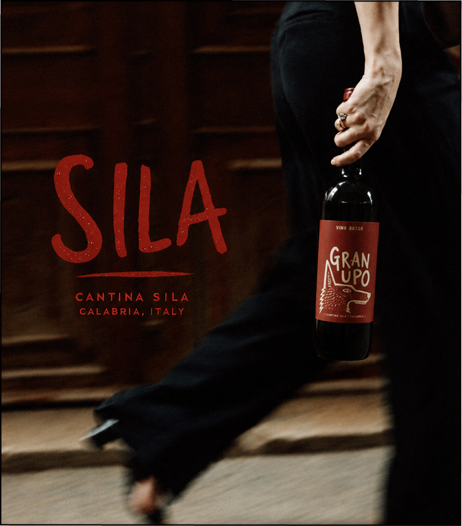Blurred still capture of a woman walking with a bottle of wine for the brand, Sila.